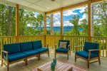 Spacious back porch with mountain views, seating, and gas fireplace.